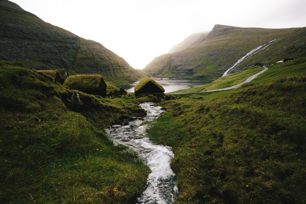 photo of a gorgeous view of the narrow river between green mountains in Saksun village