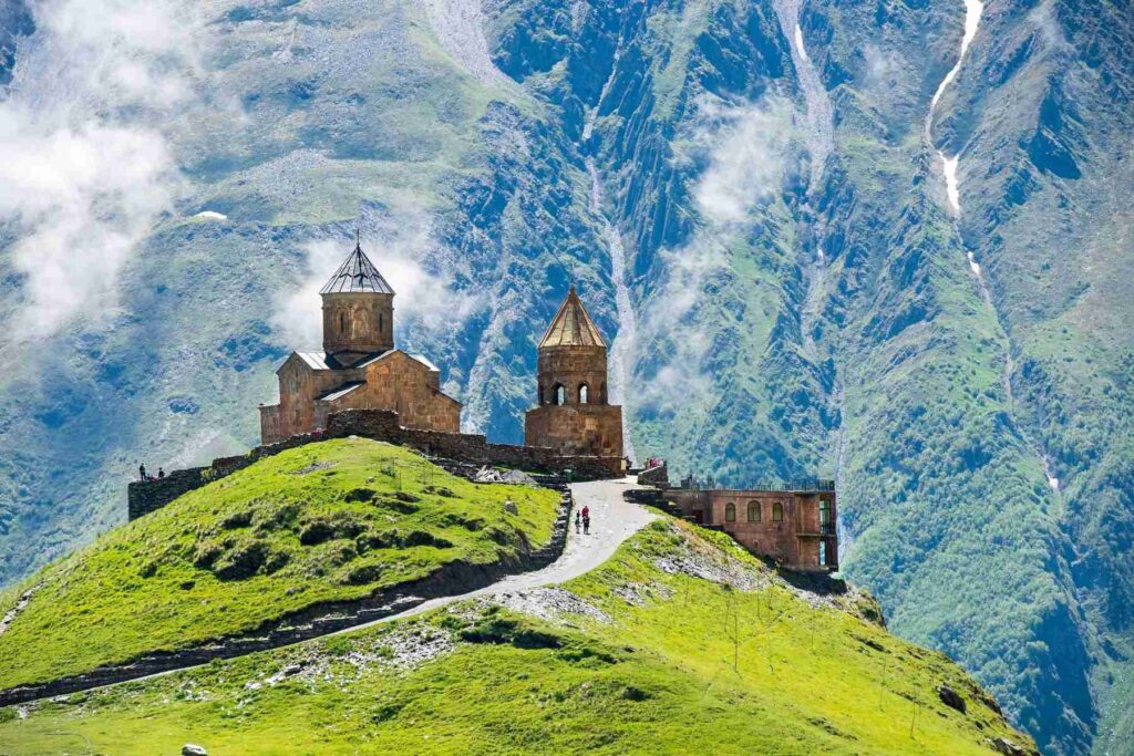 Incredible view of the Church of the Holy Trinity on a cliff top near the village of Gergeti in Georgia