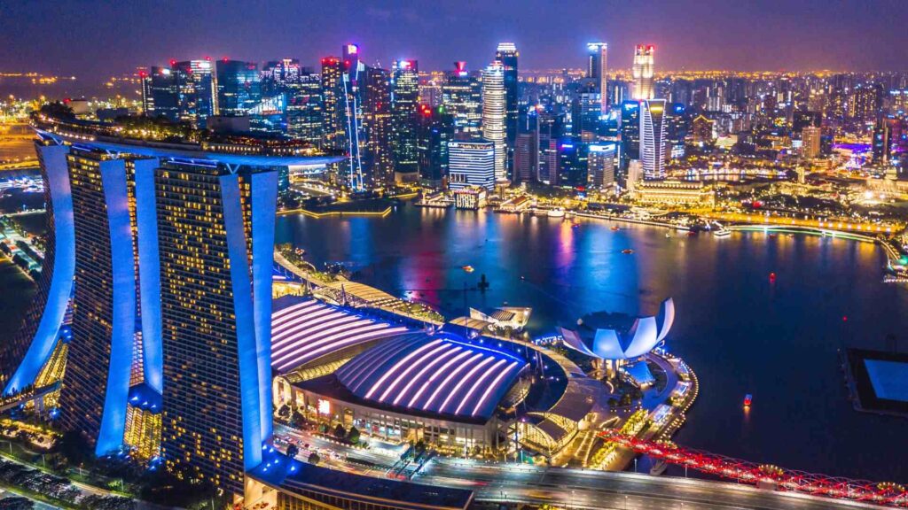 An aerial photo of Singapore at night with its amazing architecture in blue colors, Asia