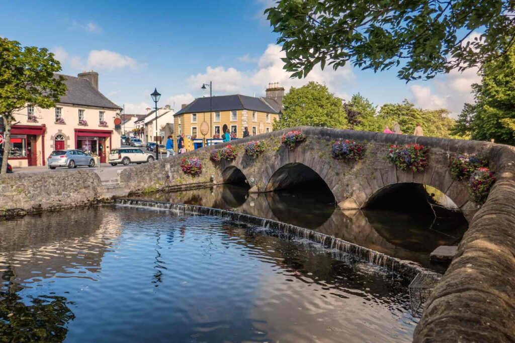 A beautiful photo of Westport Bridge in County Mayo, Ireland on a sunny day with the town in the background
