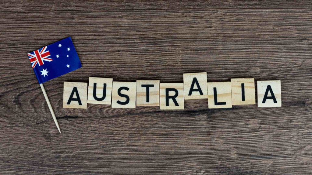 the flag of Australia and the word Australia made of cubes on the table