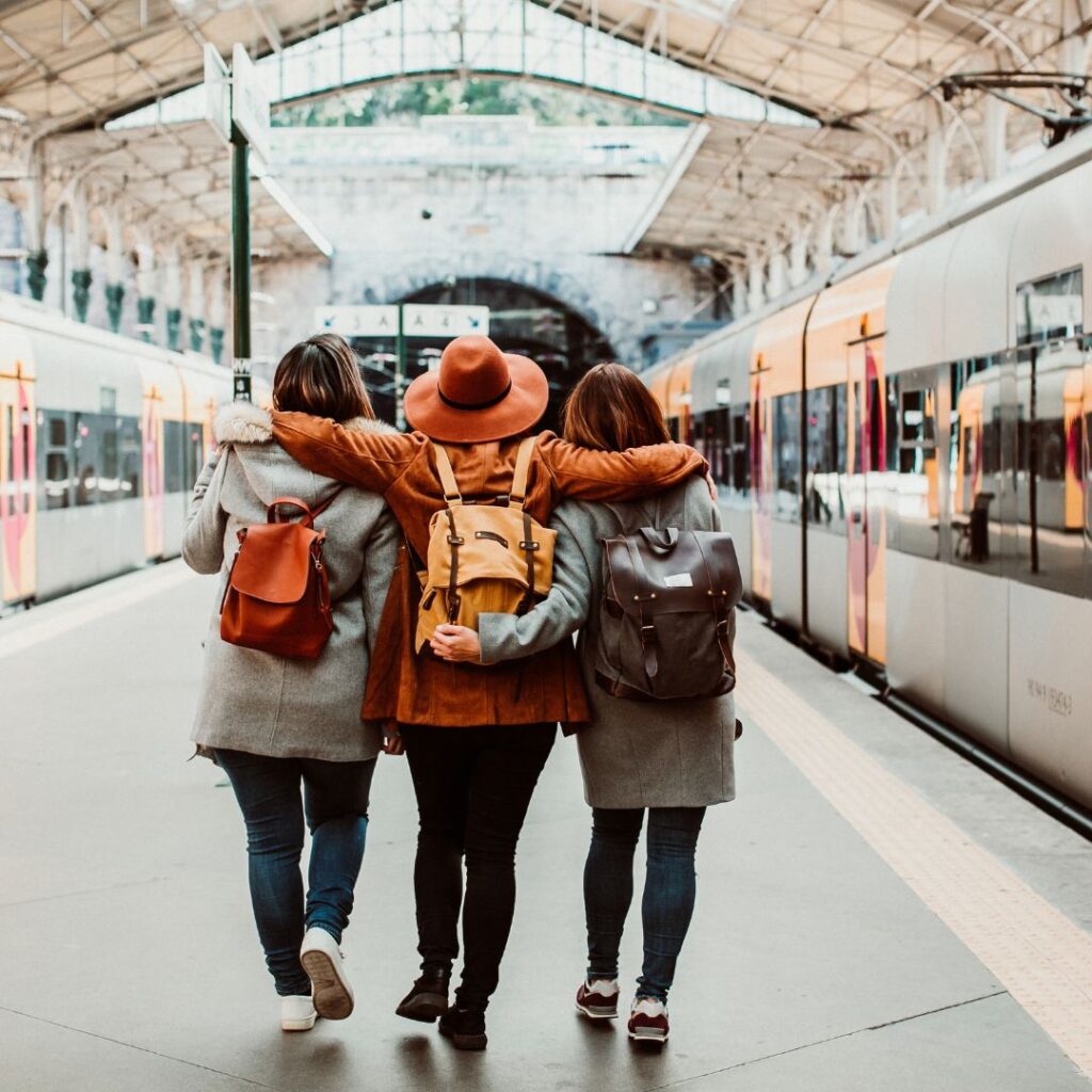3 girls walking down the platform on an international trip